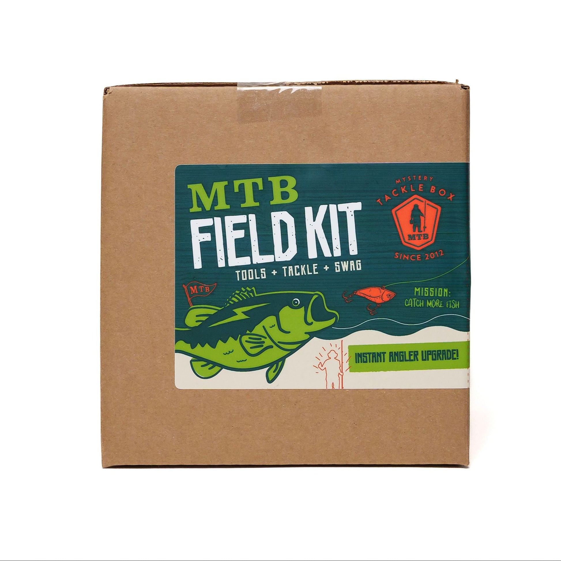 Cardboard box with 'MTB Field Kit' label featuring a fish illustration on a white background