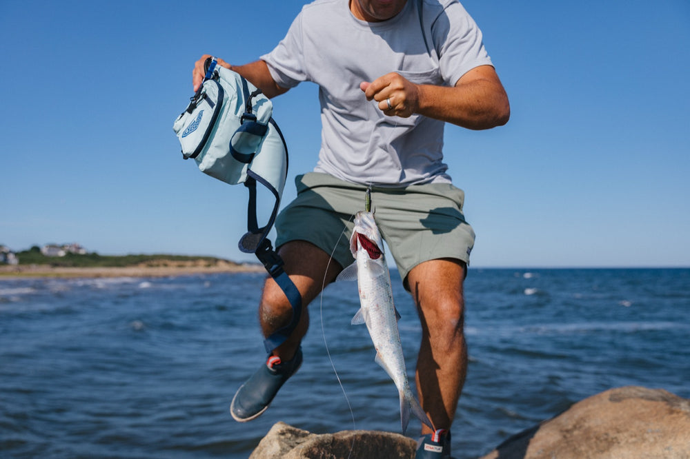 Angler with the Sea Spray bag and a fresh catch